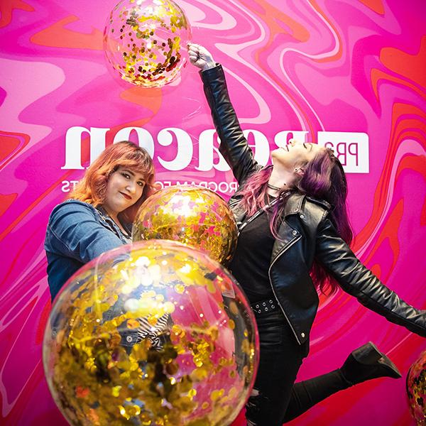 http://tj.cqkaisi.com/wp-content/uploads/2023/06/two-women-holding-balloons-in-front-of-a-pink-pba-beacon-wall.jpg